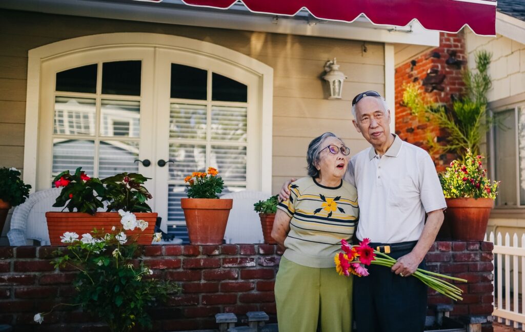 Senior couple outside their home