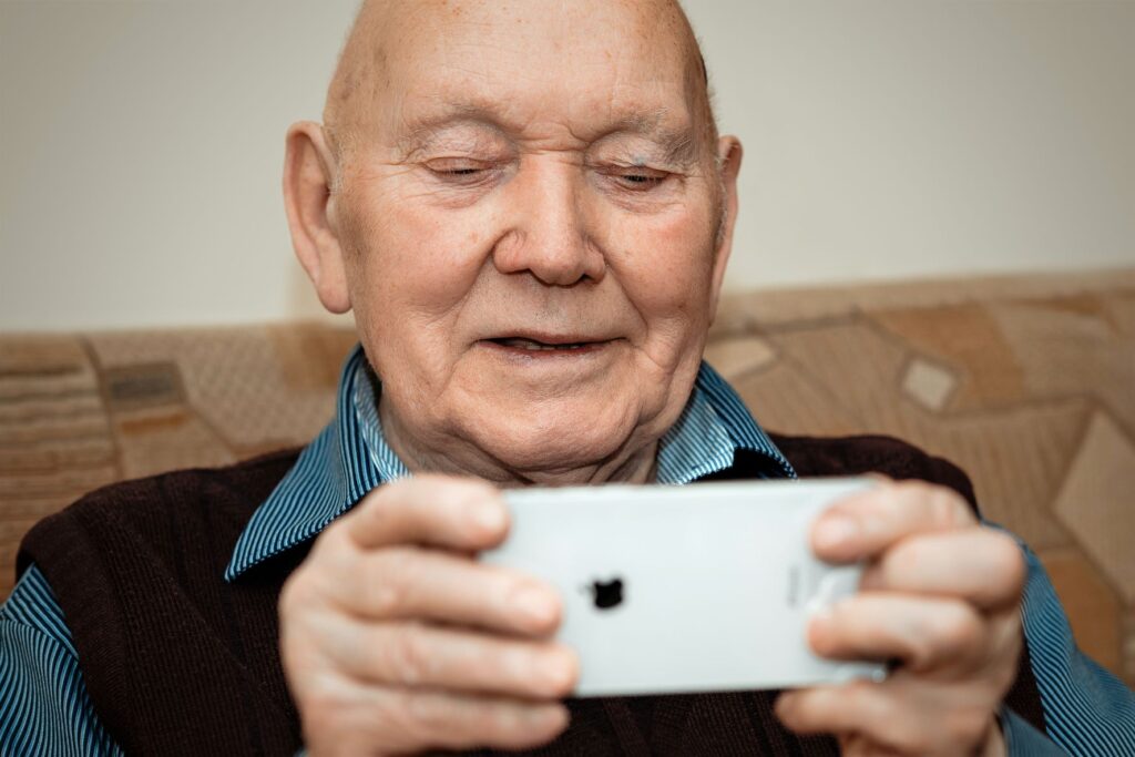 Senior man browsing social media on his smartphone